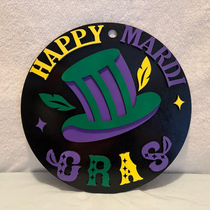 Decorative sign with 'Happy Mardi Gras' text and a green top hat on a textured surface.