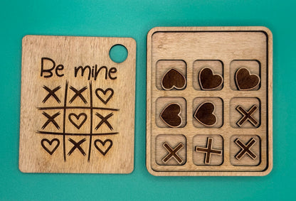 wooden board with tic-tac-toe patterns and heart designs 