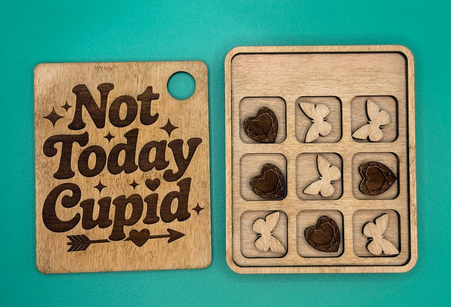 Wooden puzzle with 'Not Today Cupid' quote and heart and butterfly shapes on a teal background