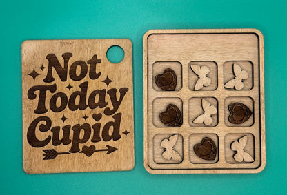 Wooden puzzle with 'Not Today Cupid' quote and heart and butterfly shapes on a teal background