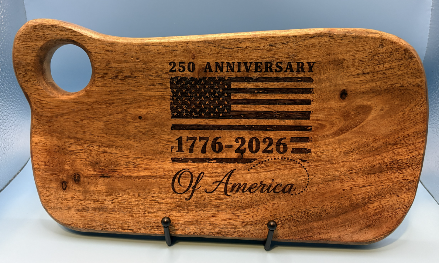 Wooden cutting board with engraved American flag and text on a light blue background