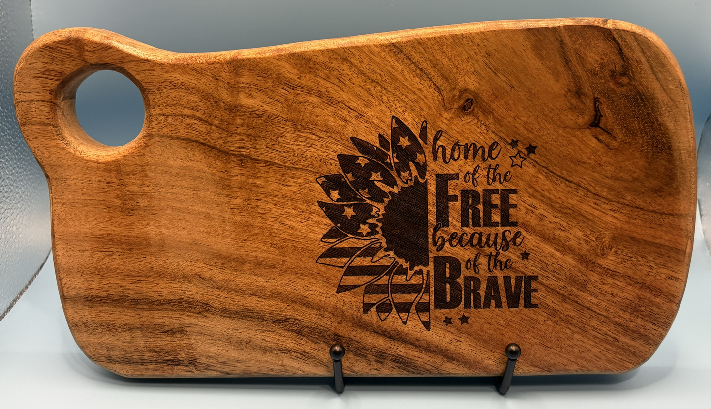 Wooden cutting board with engraved text and design on a gray background